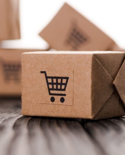 close up of small carton boxes on table isolated on white, e-commerce concept